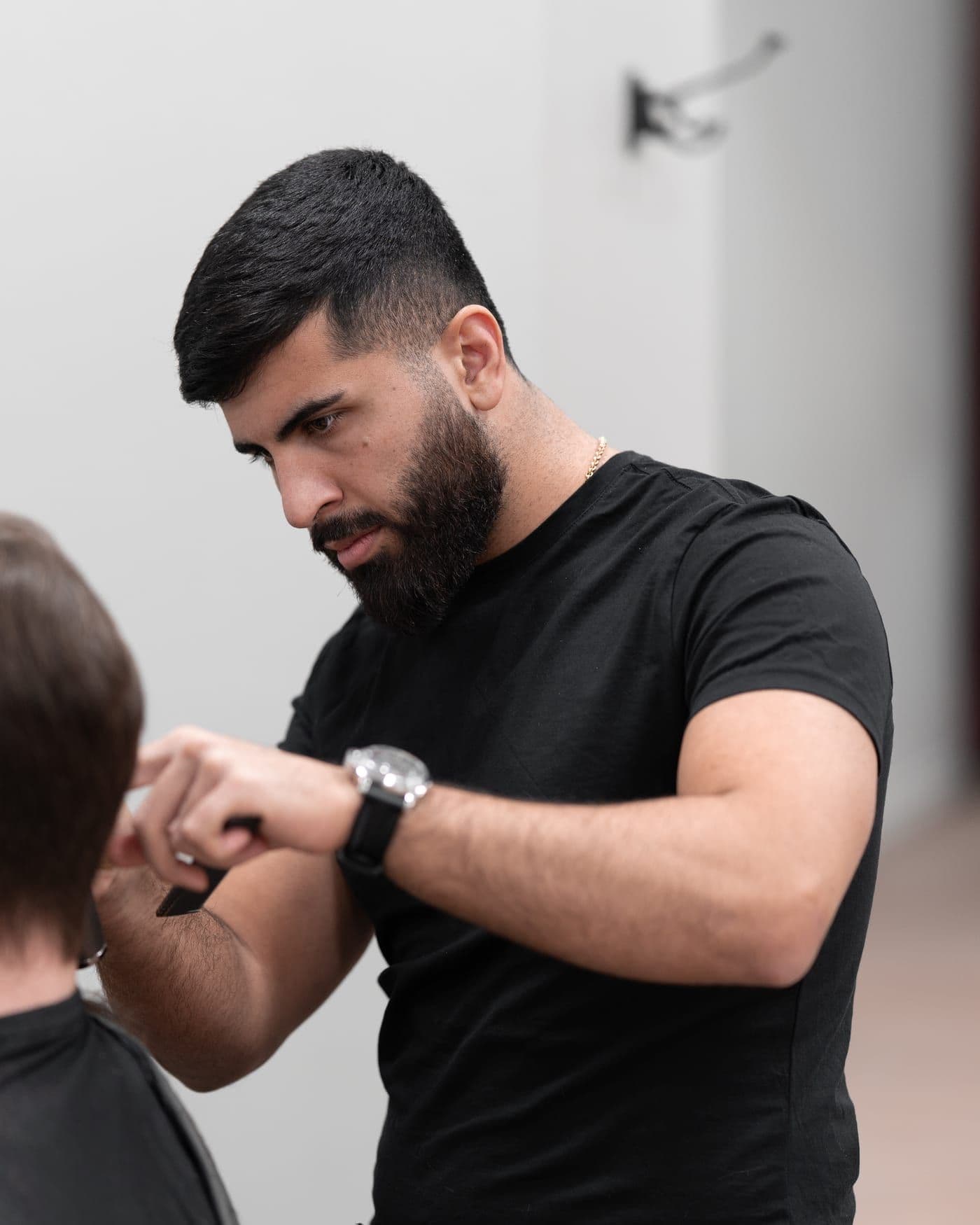 Ali Ghorbani klipper en kund hos Cityfrisörerna